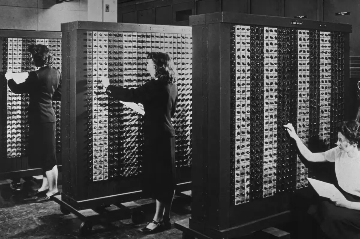 ENIAC programmers manually wiring the first electronic computer